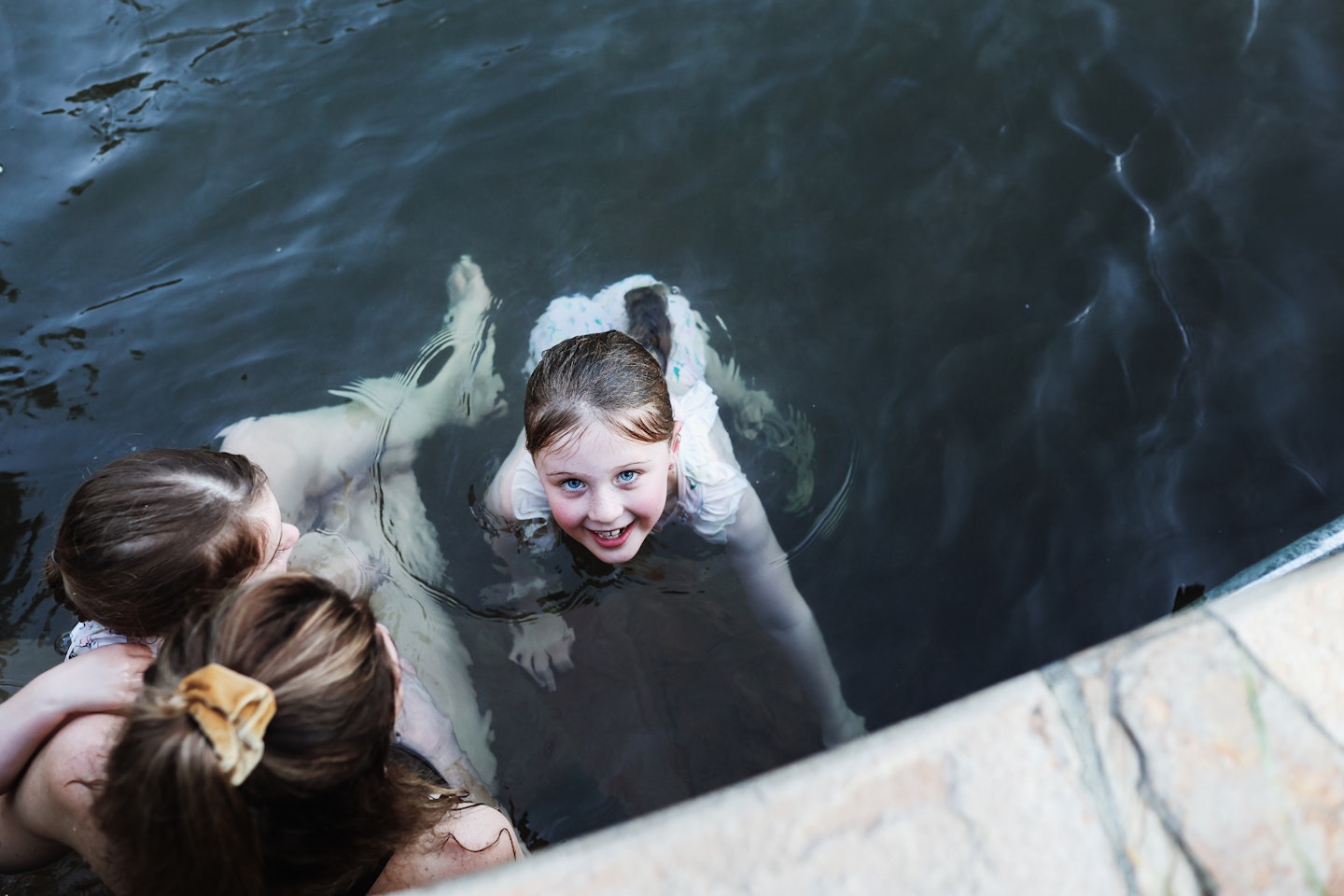 Three people bathing in hot springs