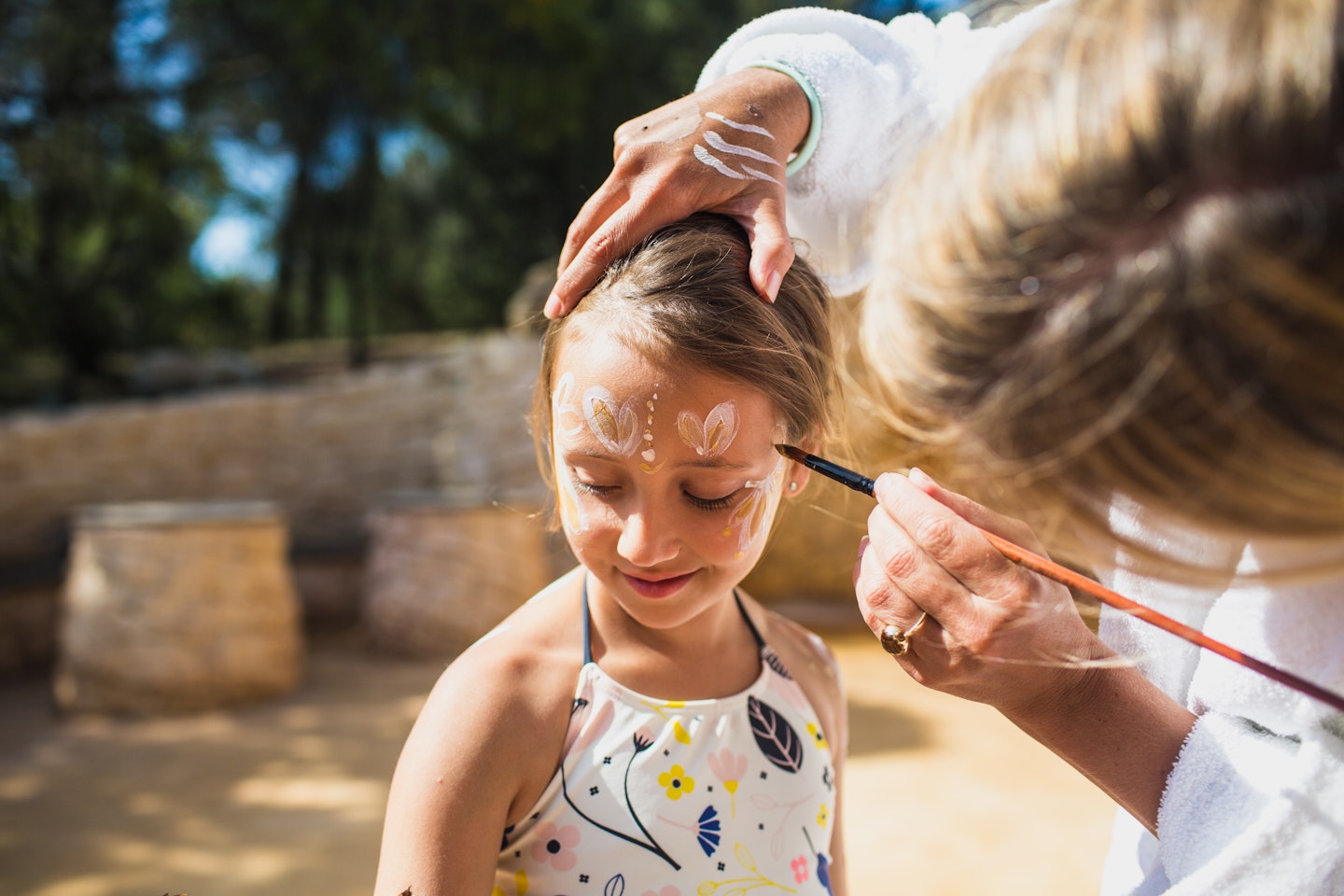 A young girl with body clay painted on her face