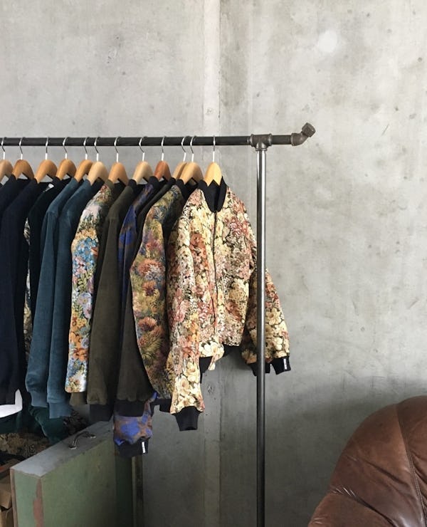 Rack of Yahmo jackets hanging in front of a concrete wall