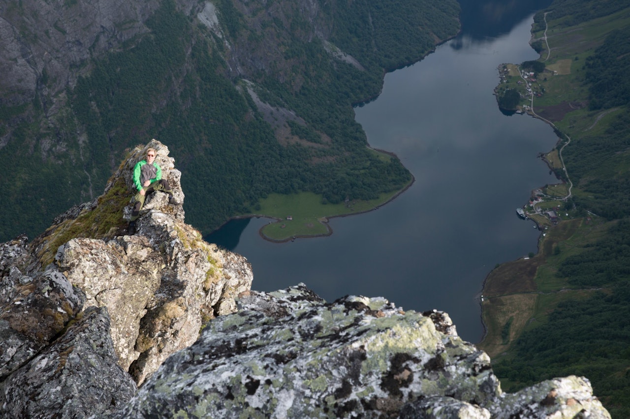 PÅ KANTEN: Stian Aadland har funnet seg en grei utsikt over Nærøyfjorden. Foto: Marte Stensland Jørgensen nærøyfjorden, stian adland marte stensland jørgensen
