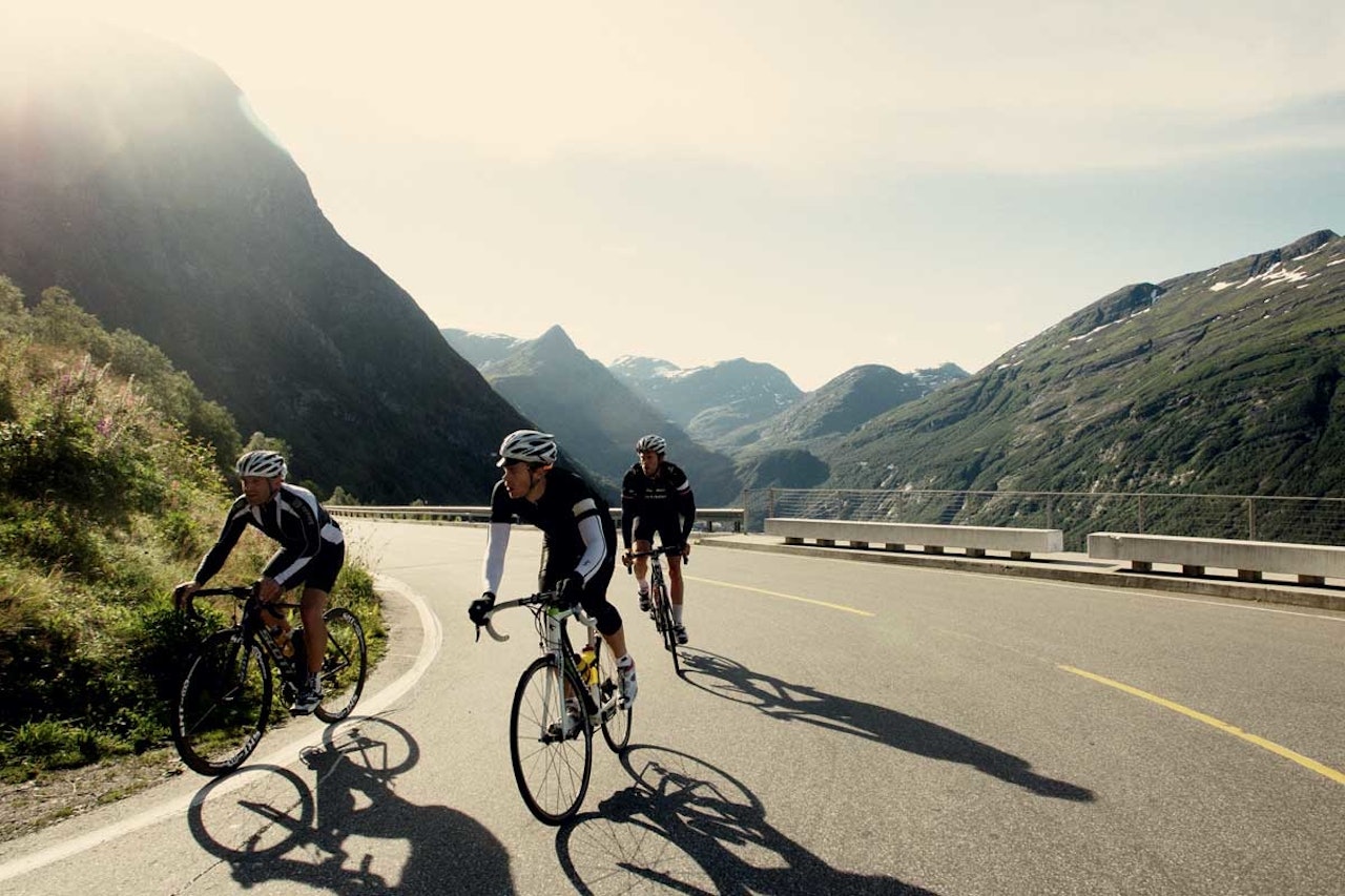 Veien slynger seg opp fra fjorden , og skyggene blir lange. motbakkesykling motbakke bakkesykling landevei cycling Norge 71 bakker du må sykle i Norge fri flyt procycling gruppetto strava segment Ørnesvingen Ørnevegen Geiranger Fjord Hellesylt
