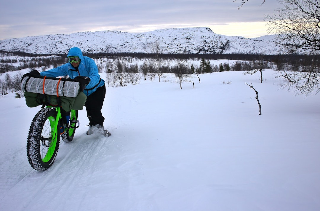 Mange av kilometerne over vidda måtte Mikhail Itkin dytte sykkelen gjennom snøen. Foto: Privat pushing bike around Kirkenes - Privat 1400x924 web