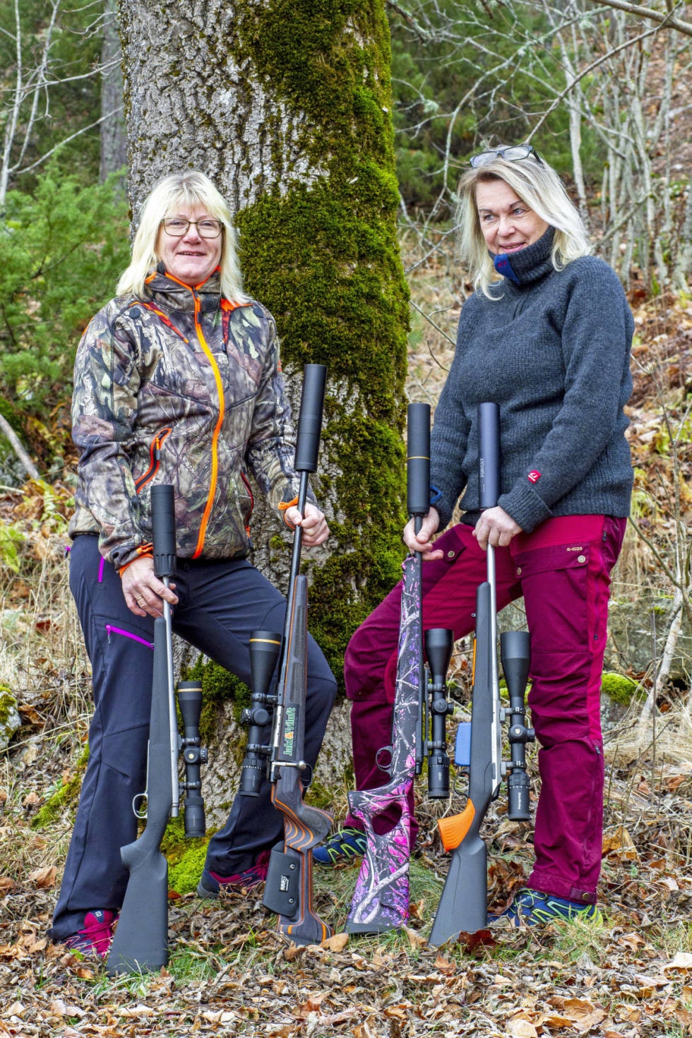 To kvinnelige jegere med fire rifler.