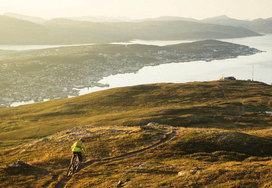FJELLHAVSBYEN: Tomas Løkken tar fatt på utforkjøringen ned mot Tromsø fra Bønntua en sen sommerkveld. Tromsø sykling