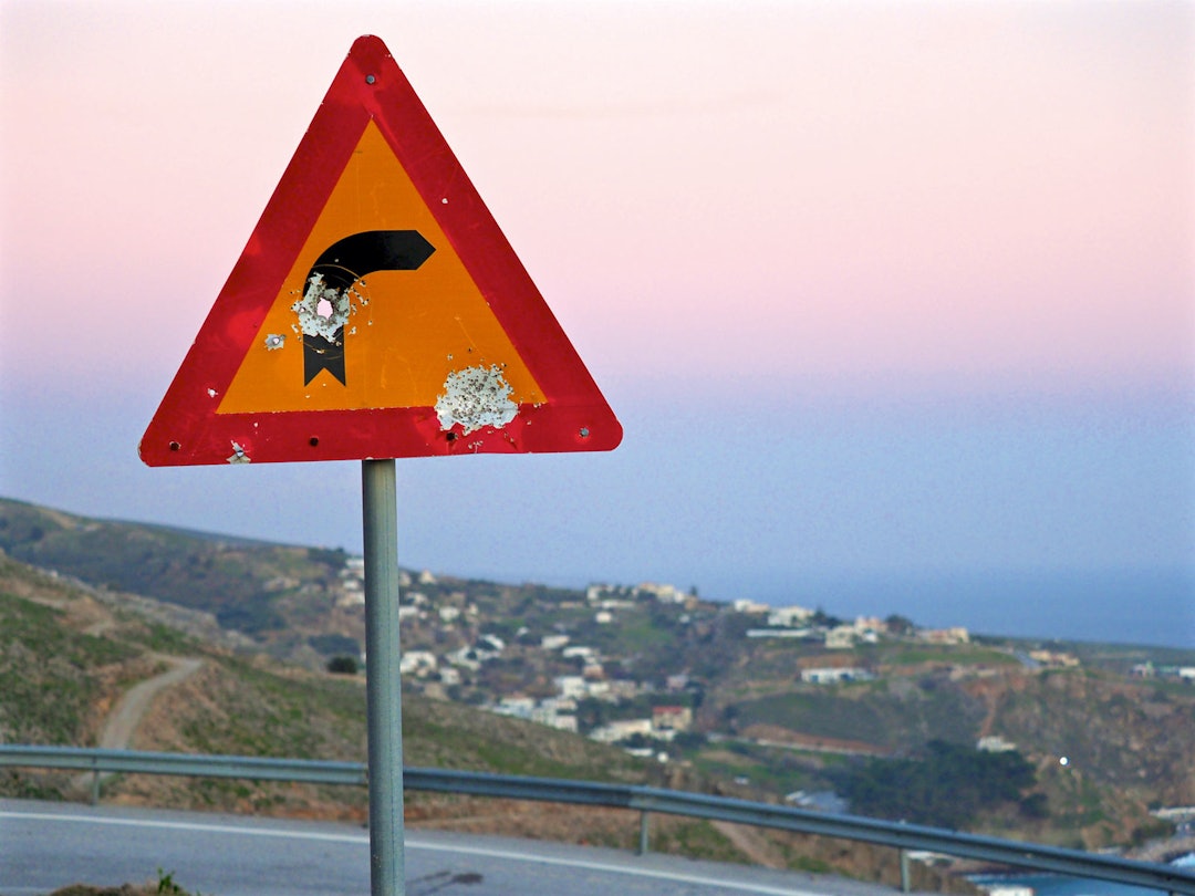 TEXAS: Mannfolka på Kreta har skjegg, svarte klær og pistol eller revolver. Dermed ser veiskiltene sånn ut. Kreta-topptur-8.3