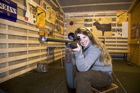 Ung jente på skytebanen med rifle til jakt