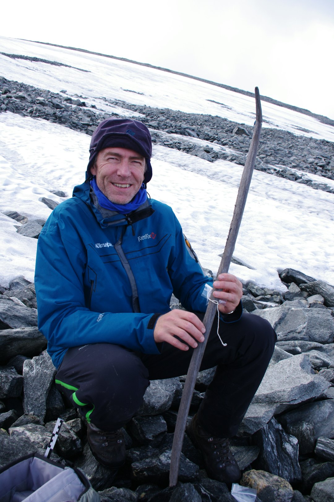 Jostein Bergstøl med bue fra bronsealderen. En enda eldre bue kan ses på utstillingen. (Foto: Espen Finstad, Innlandet fylkeskommune) Arkeolog med bronsealder-bue funnet i snøfonn.