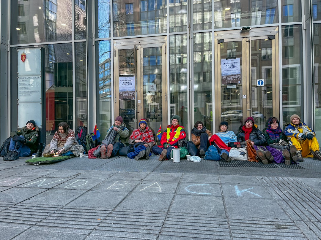 STENGER INNGANGEN: Demonstrantene sitter foran Regjeringskvartalet. Ikledd ullgensere, tjukke jakker og pledd har de stålsatt seg for å sitte på den kalde asfalten i mange timer. Foto: Line Victoria Sverdrup demonstranter regjeringskvartalet
