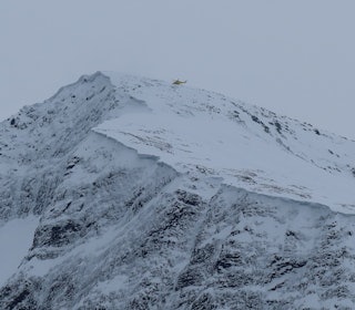 helikopter over snøkledt fjell