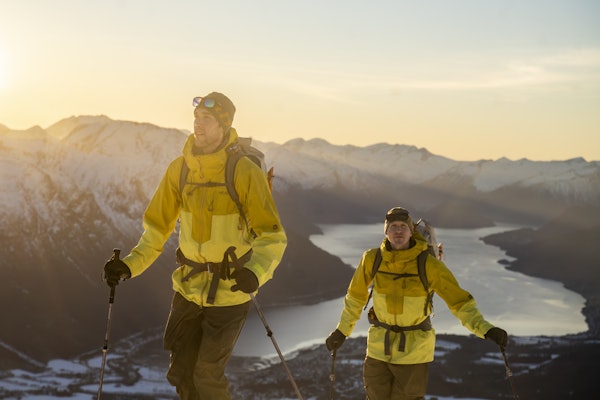 ERFARNE FJELLFOLK: Nå blir det mulig å kjøpe langtidskursing i alpin ferdsel av folk som snowboardlegende Krister Kopala (til høyre) og tindevegleder Jonas Østrem, som sammen med Thea Kopala Røhme lanserer Alpinprogrammet. Foto: Anders Vestergaard to karer på fjelltur med fjord bak