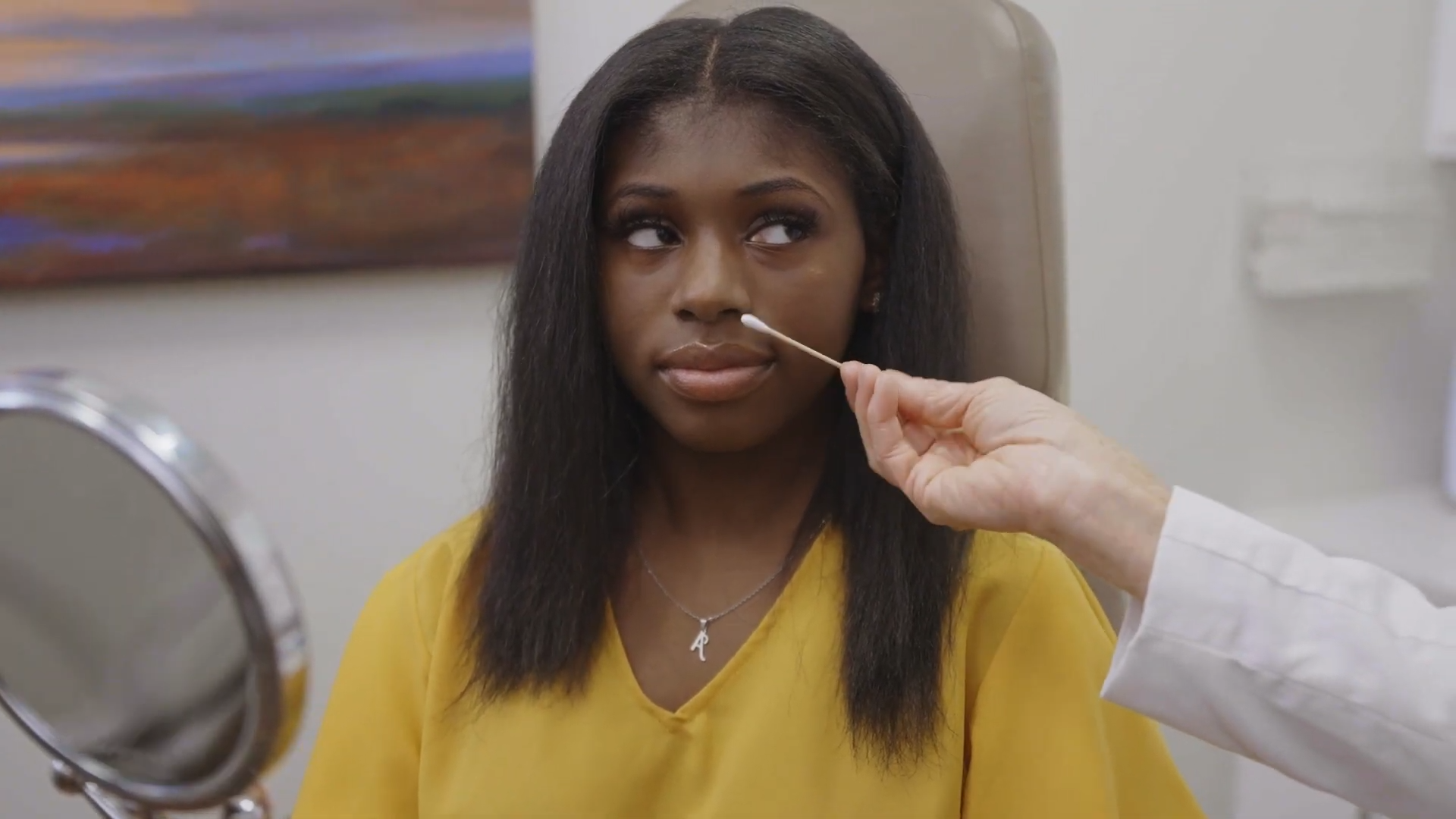 Doctor analyzing patient nose with cotton swab