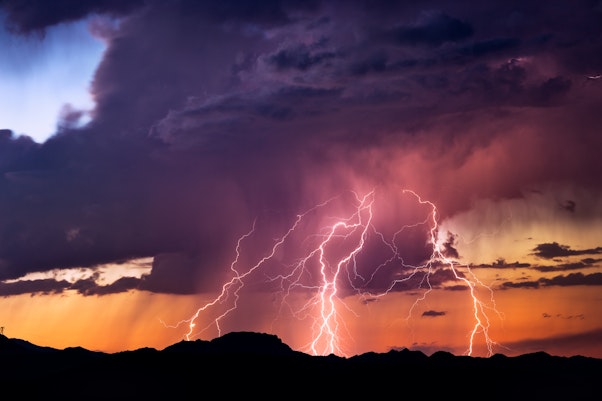 Lightning strikes in purple sky