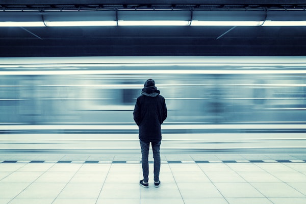 Person standing alone in subway station