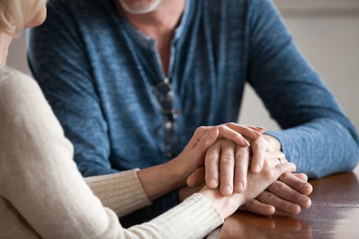 Two people comforting each other