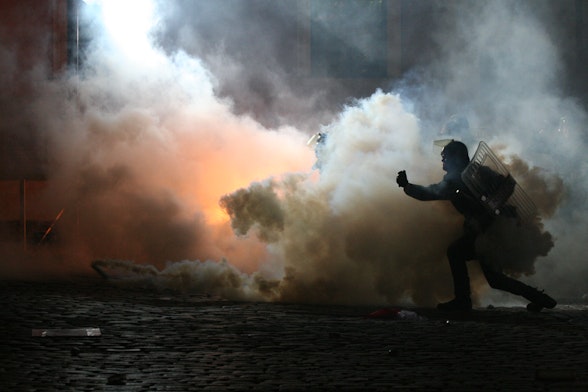 Smoke and armed officer in place of civil unrest