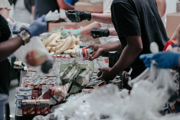 group of people on a christian mission trip providing food and groceries to impoverished community.