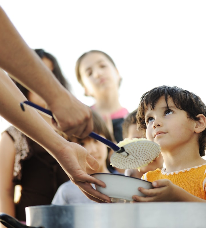 Volunteers providing food to children on an Islamic Mission Trip