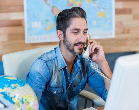 NGO travel agent making arrangments over the phone