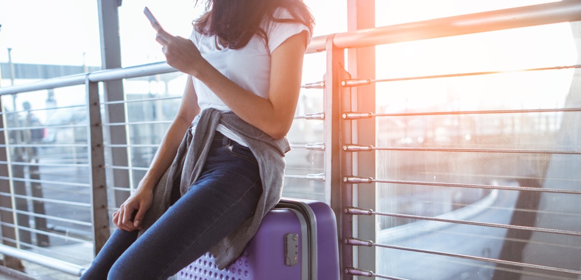 girl sat on suitcase