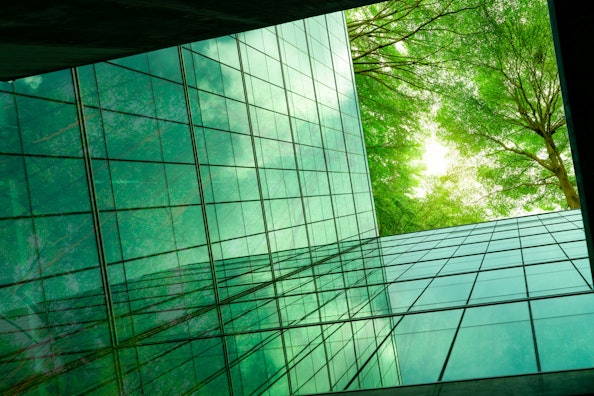 Een milieuvriendelijk gebouw in een moderne stad, omgeven door bomen