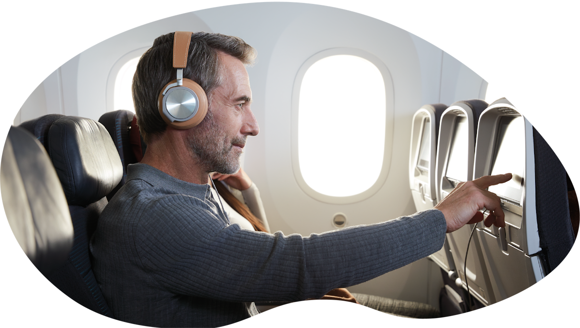 A man using the entertainment screen on a plane