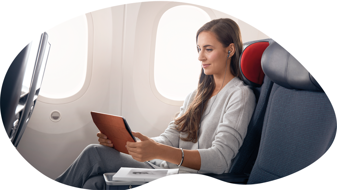 A woman working with a tablet on a plane