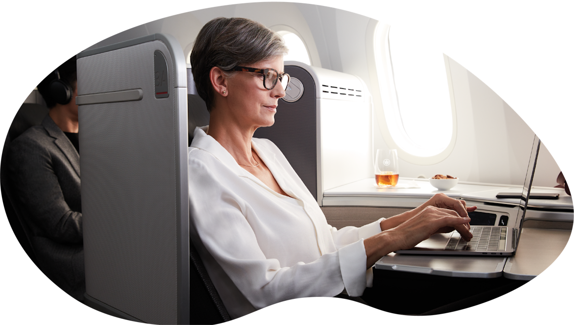A woman working on her laptop onboard a plane