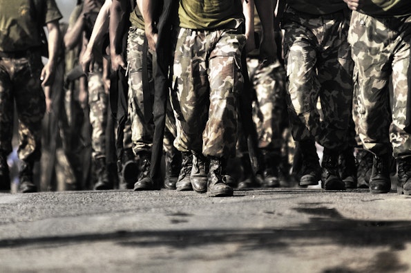 Military men walking towards a camera