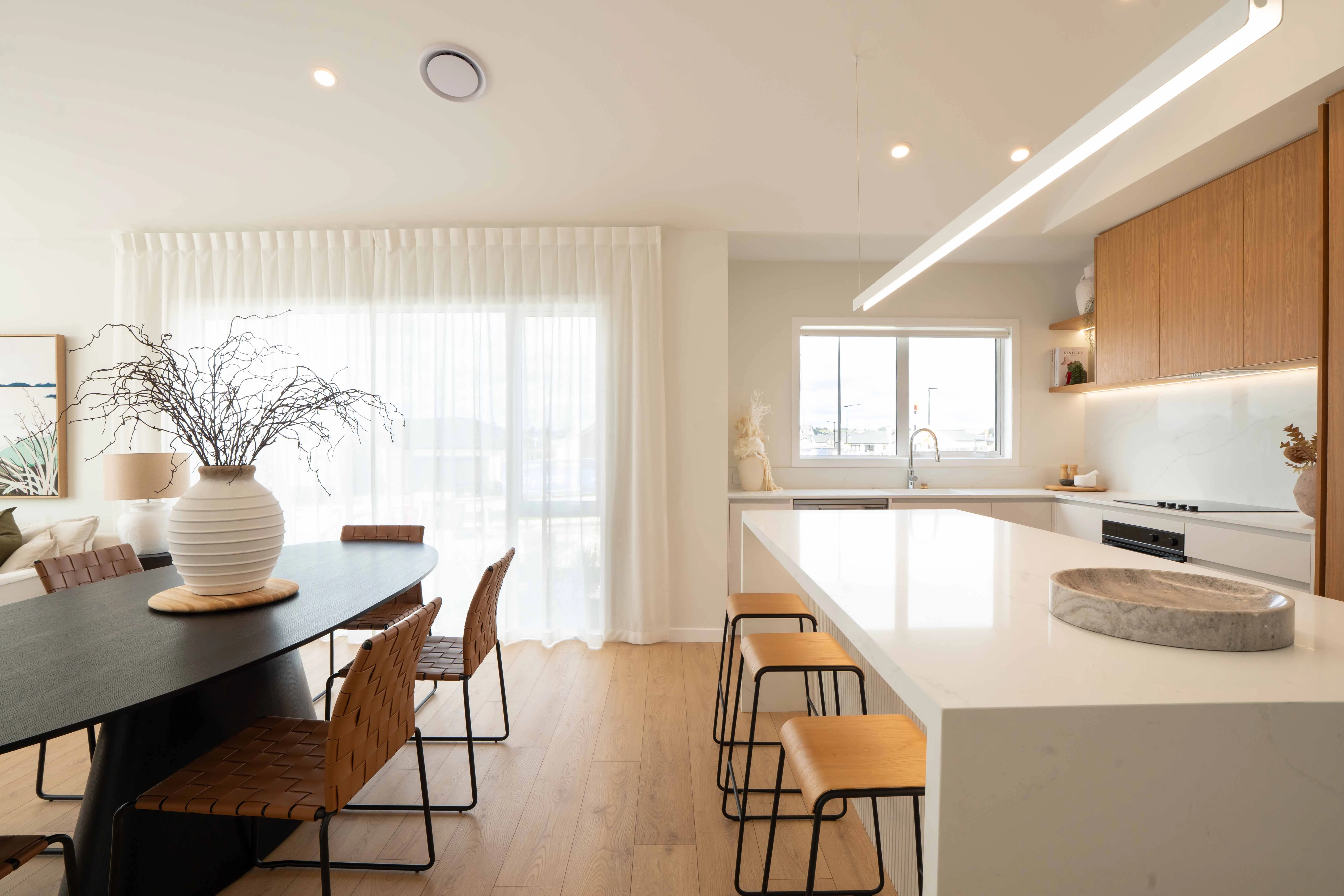 Milldale showhome kitchen and dining area with stone island, modern finishes, and open-plan design
