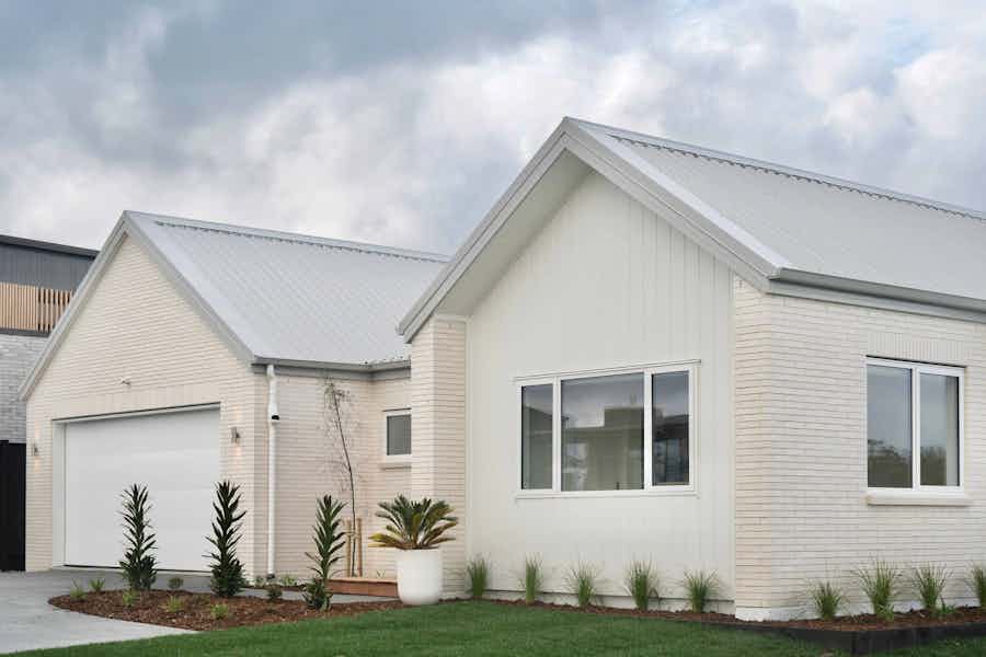NZ house with white cladding and brick cladding
