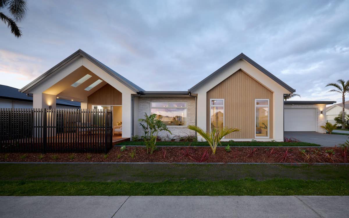 Contemporary house exterior in New Zealand with Scandinavian inspired design, timber and stone cladding, and family-friendly single level layout