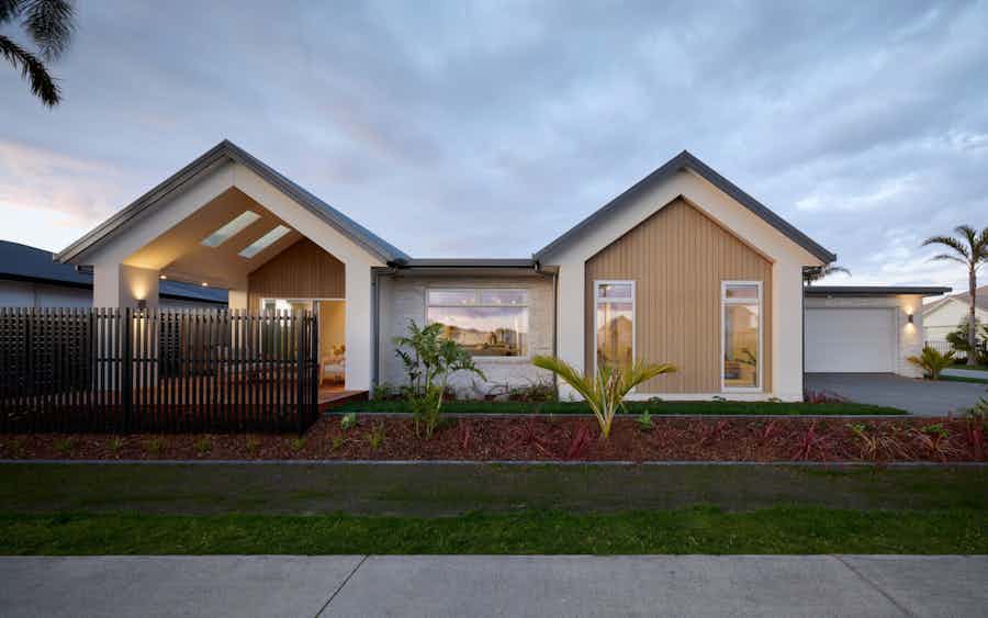 Contemporary house exterior in New Zealand with Scandinavian inspired design, timber and stone cladding, and family-friendly single level layout