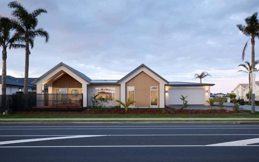 Modern gable roof home in New Zealand with timber cladding, large windows, and landscaped front yard – Signature Homes contemporary showhome design