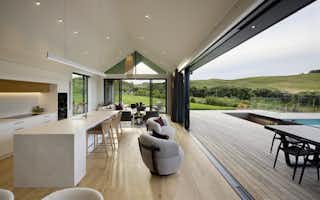 open plan kitchen and dining area onto large decking and pool area