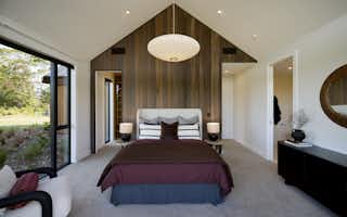 Custom wooden bedroom headboard with large walk in wardbrobe