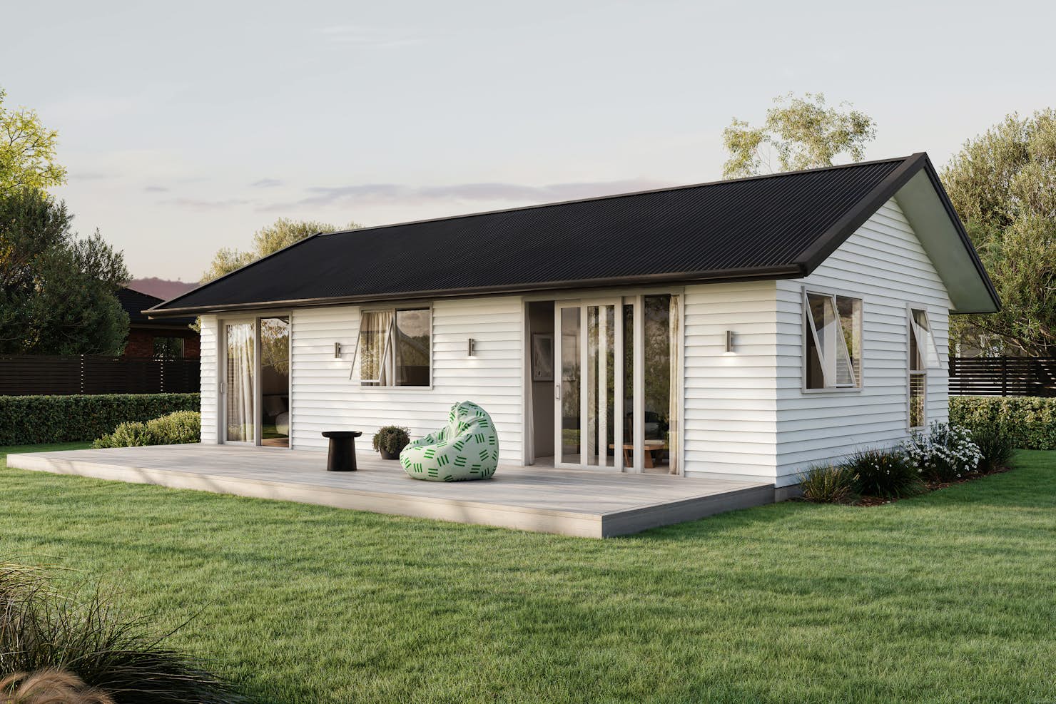 Signature Homes Minor Dwelling home with white weatherboard cladding, dark grey steel roof and light timber decking