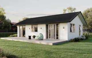 Signature Homes Minor Dwelling home with white weatherboard cladding, dark grey steel roof and light timber decking