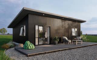 Small minor dwelling home with dark vertical cladding ideal for a beach house and air bnb rental