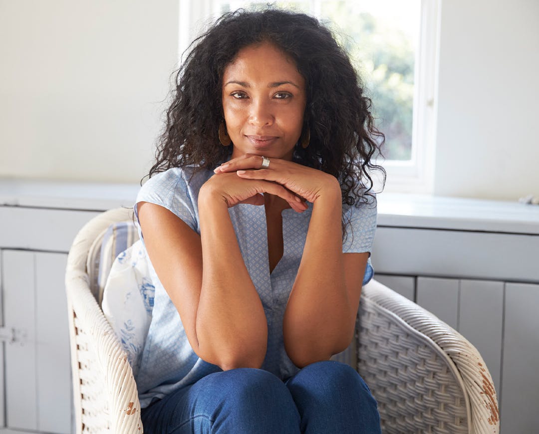 woman sitting in chair smiling at the camera