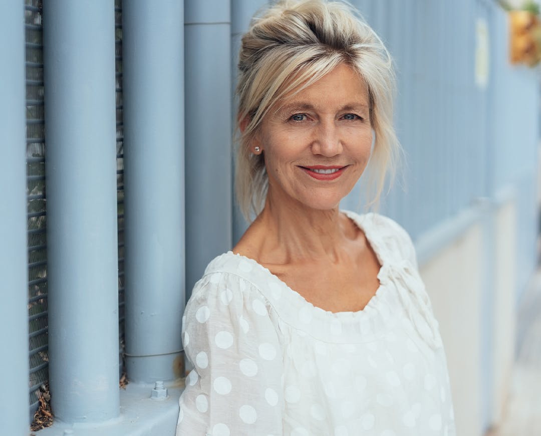 woman in white looking at camera