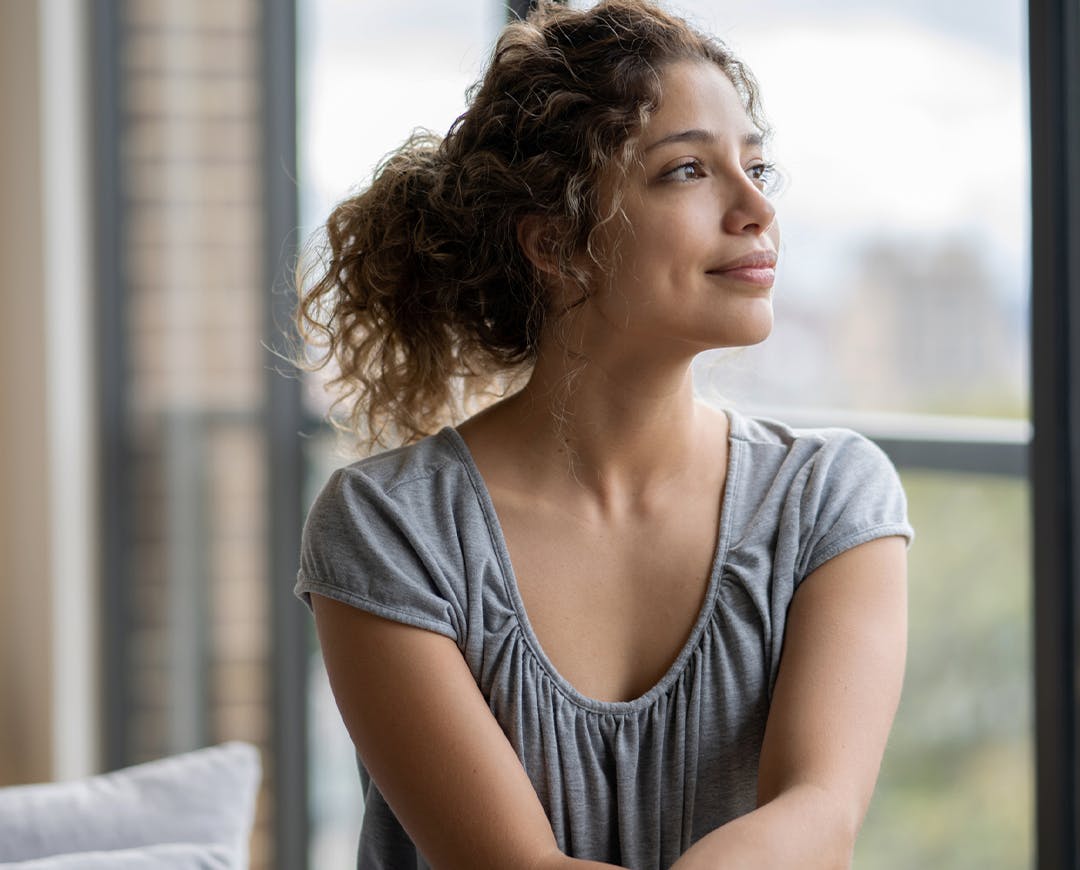 woman in gray shirt looking to her left