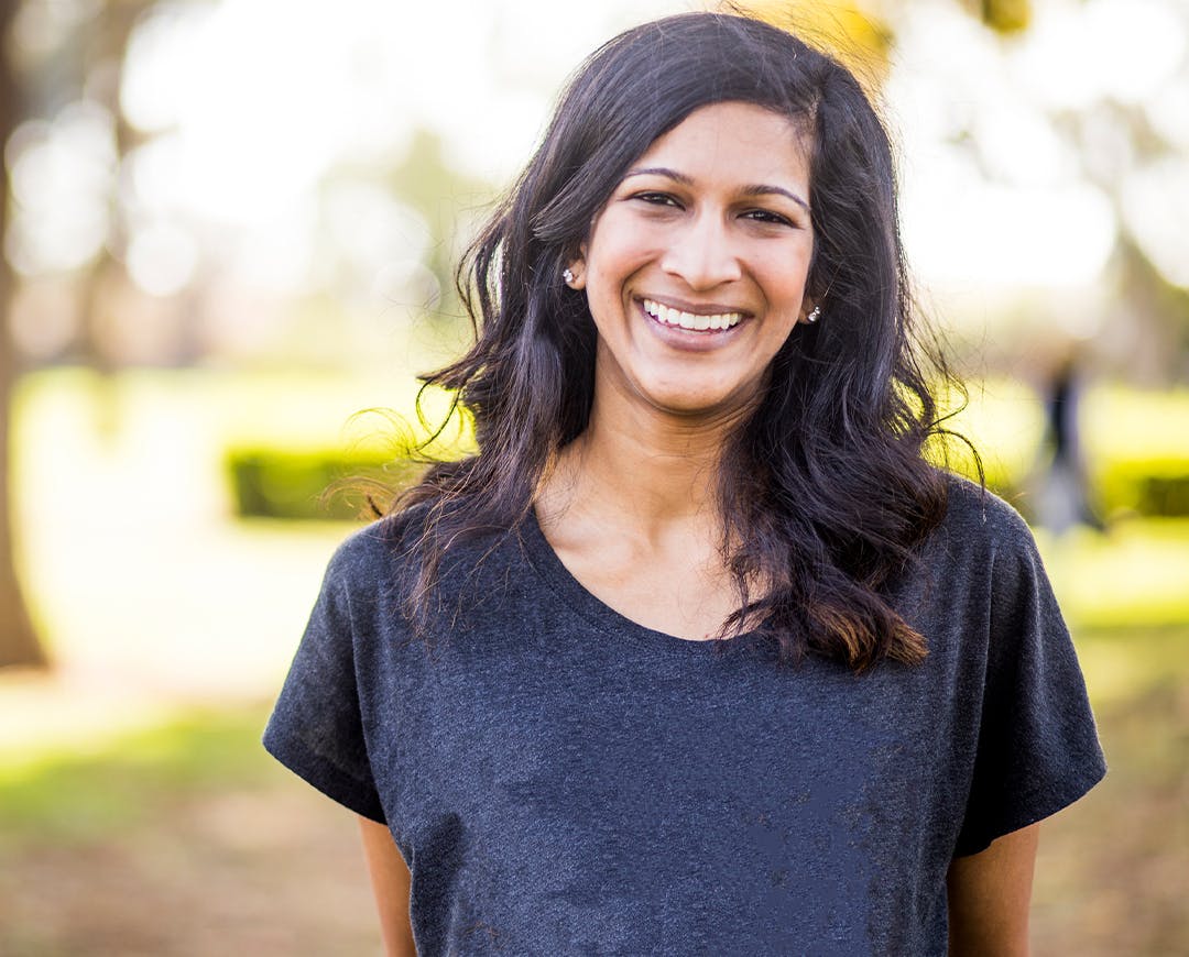 woman in a navy blue shirt smiling