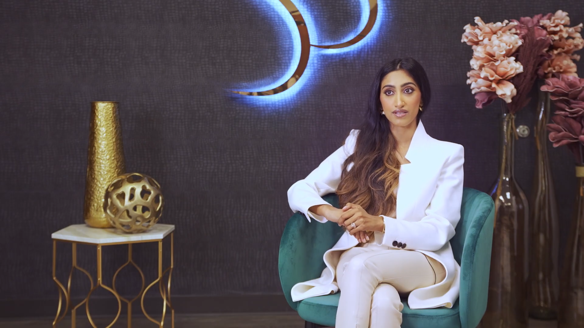 Dr Srinivasa sitting on a couch facing the camera