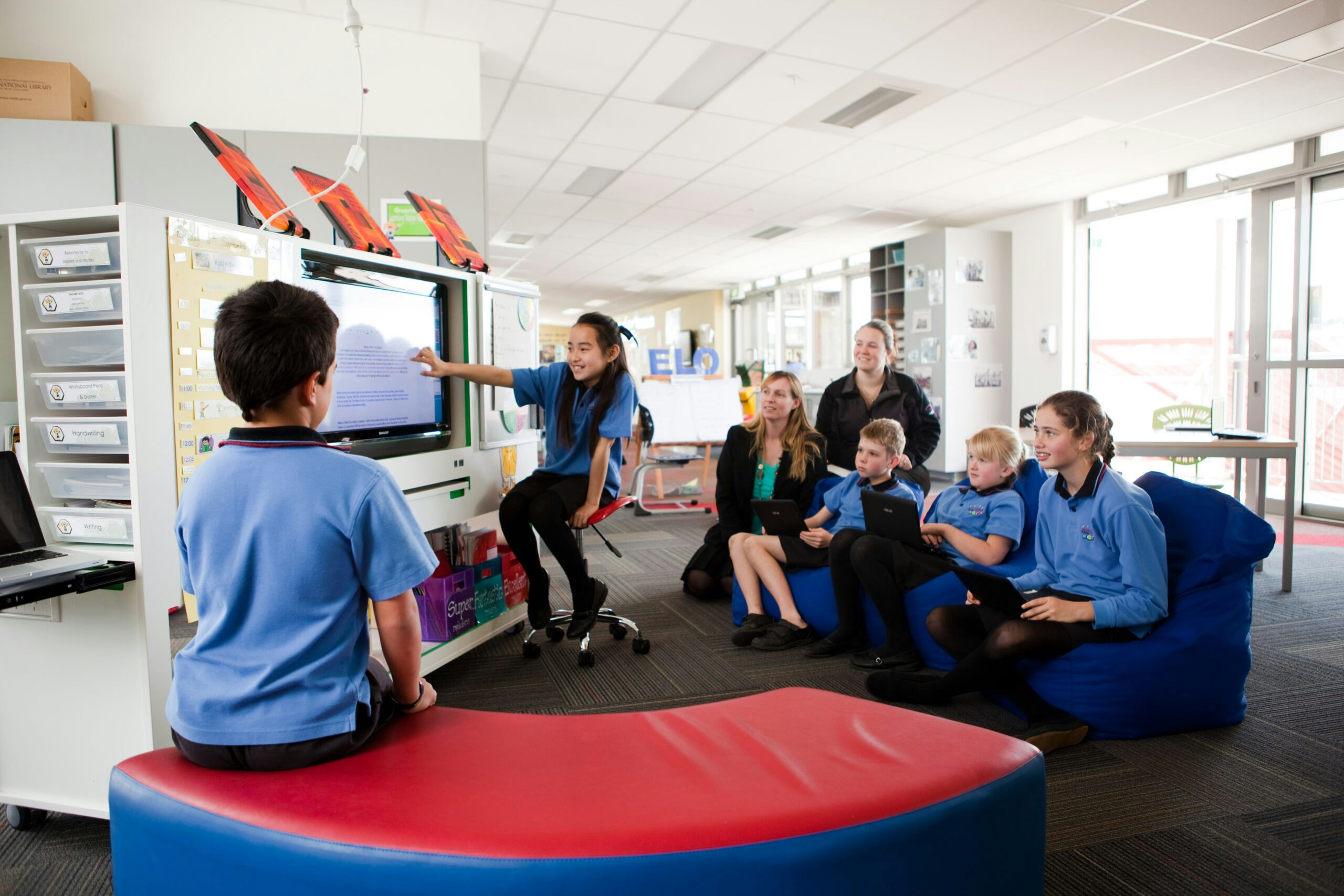 Students around a TV in class