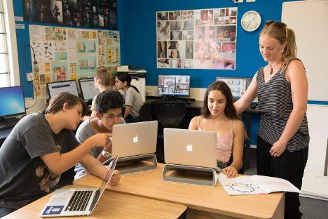 Teacher with students on laptops