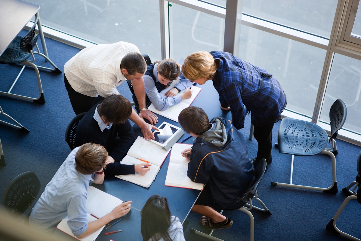 Two teachers collaborating with students