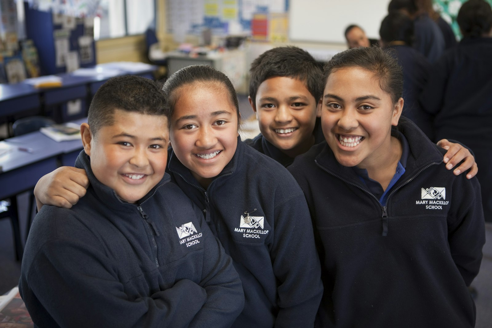 A group of students standing together in a classroom