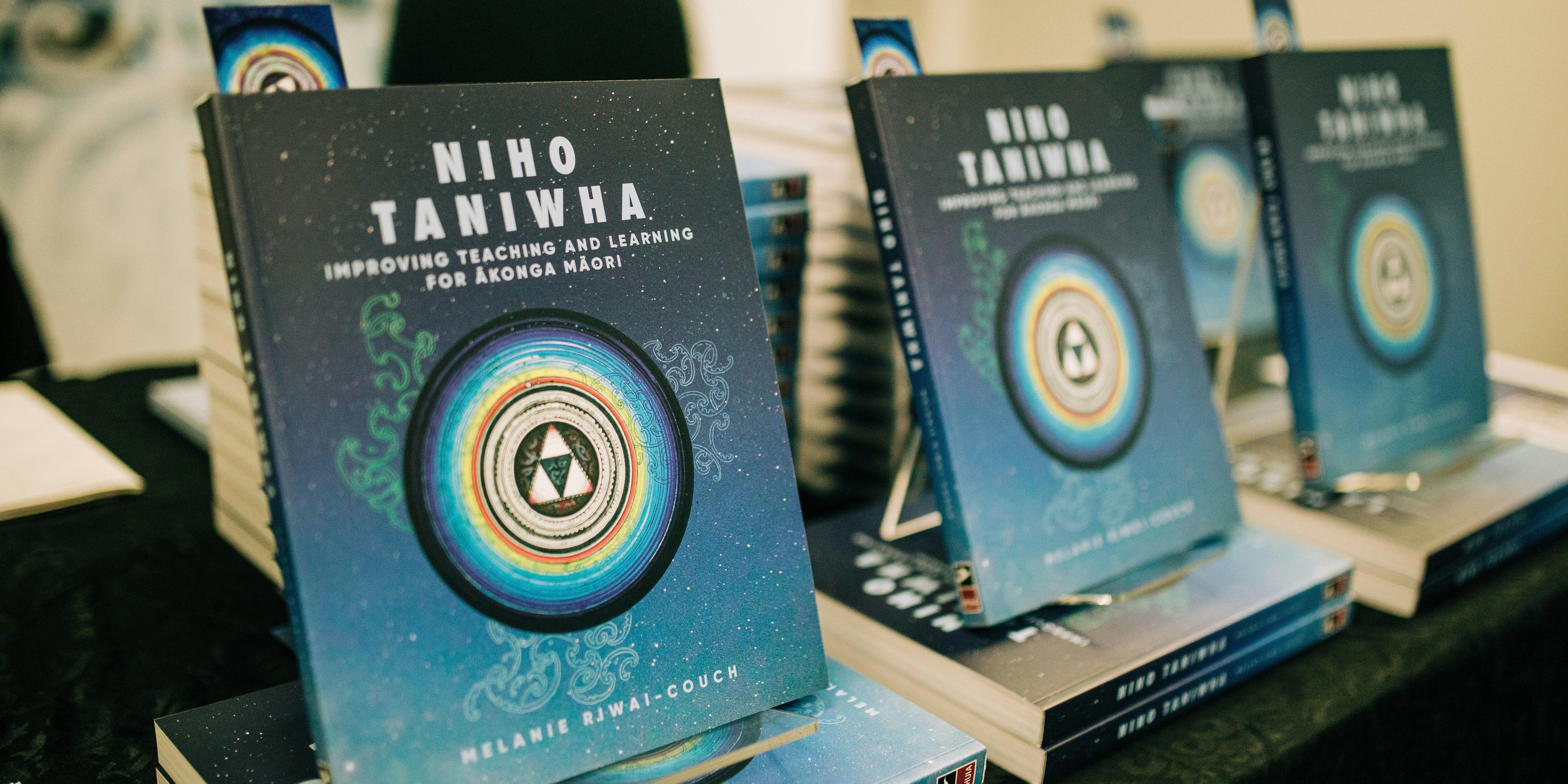 Copies of 'Niho Taniwha' written by Dr Melanie Riwai-Couch displayed on a table