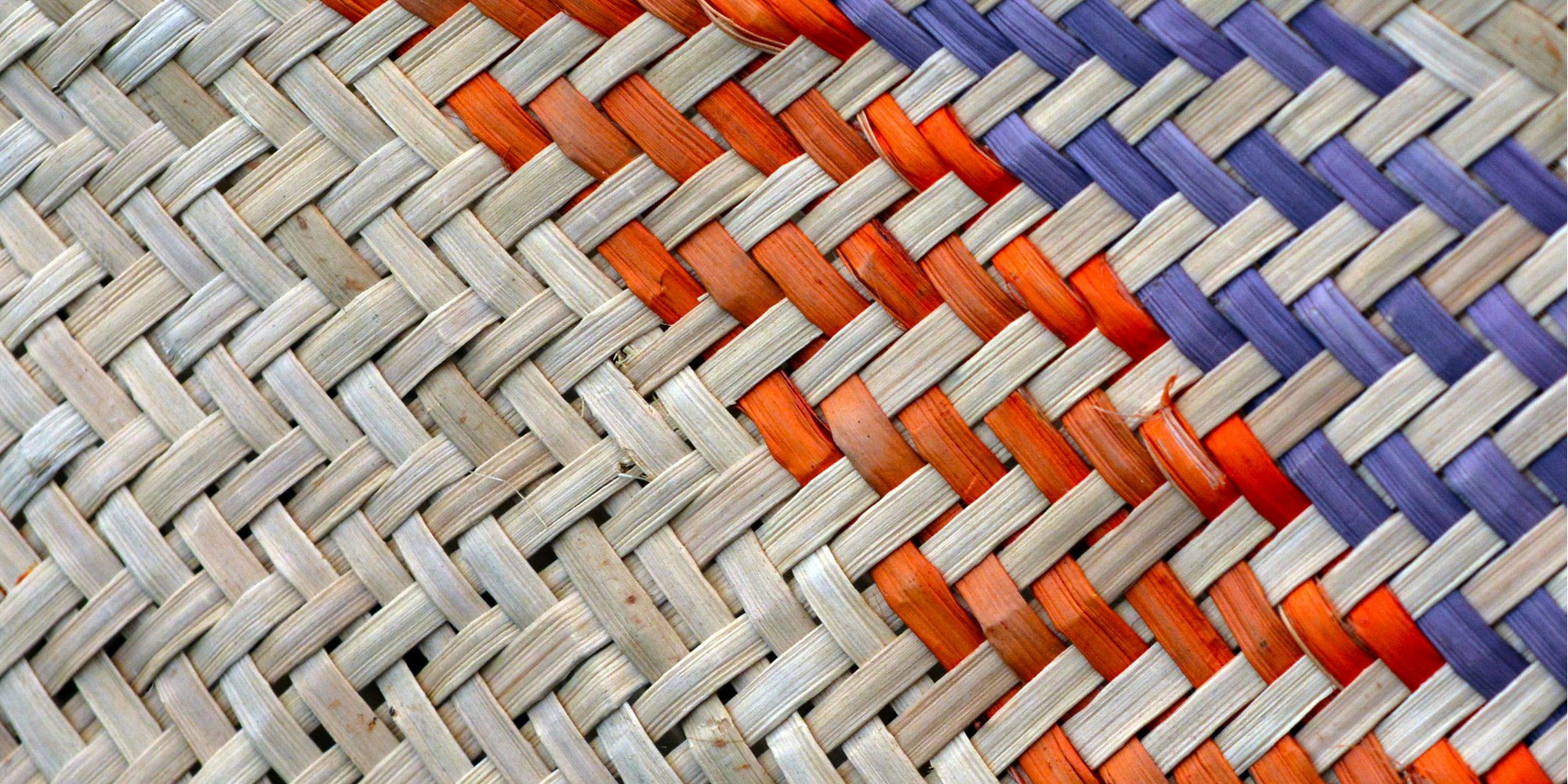 Woven kete with orange and blue flax