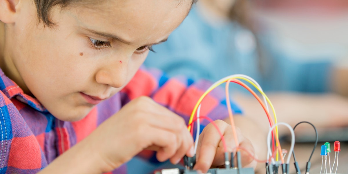 Boy looking intently at some science equipment